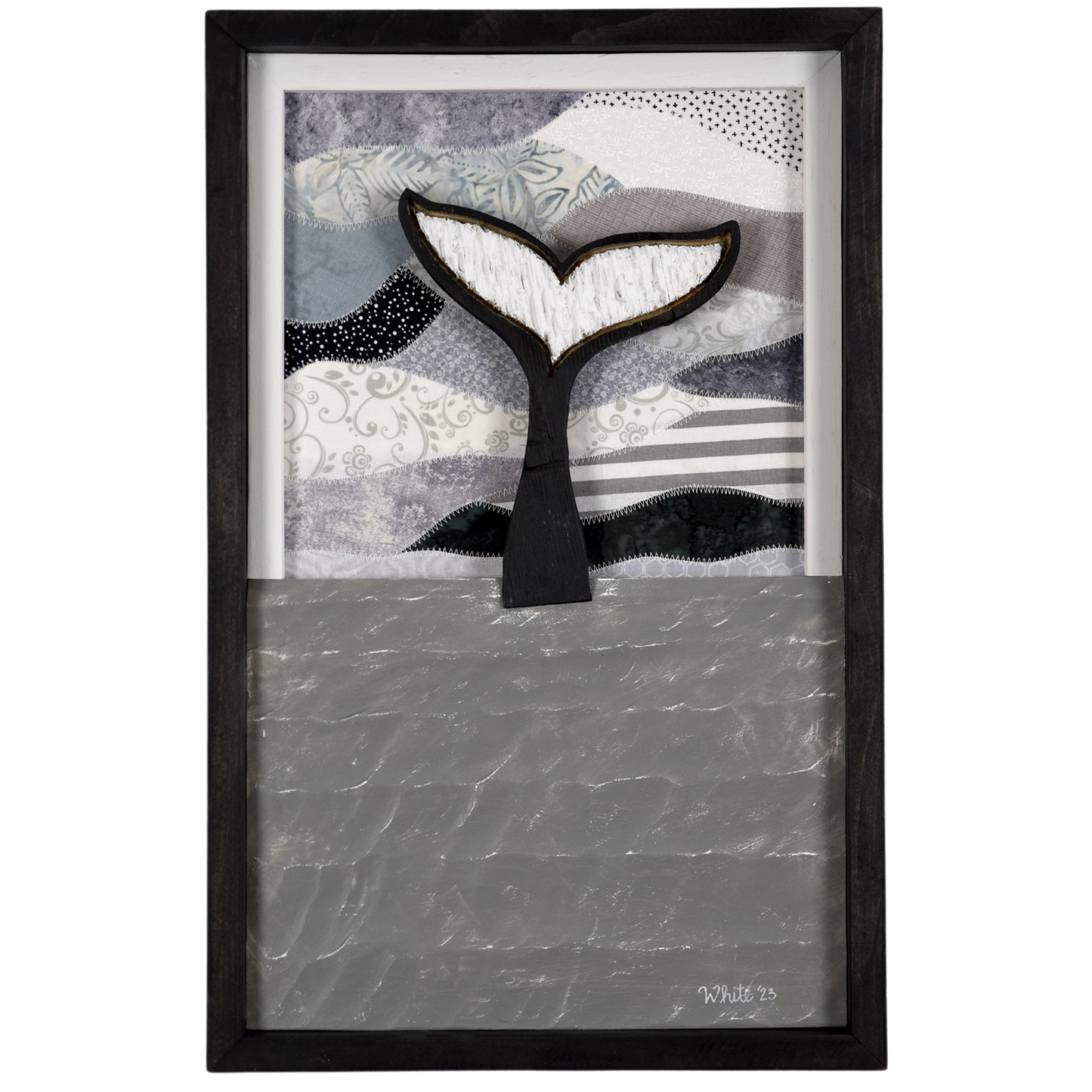 Shop for Newfoundland driftwood art at The White's Emporium. This mixed-media piece shows a whale tail diving into the water against a quilted fabric sky.