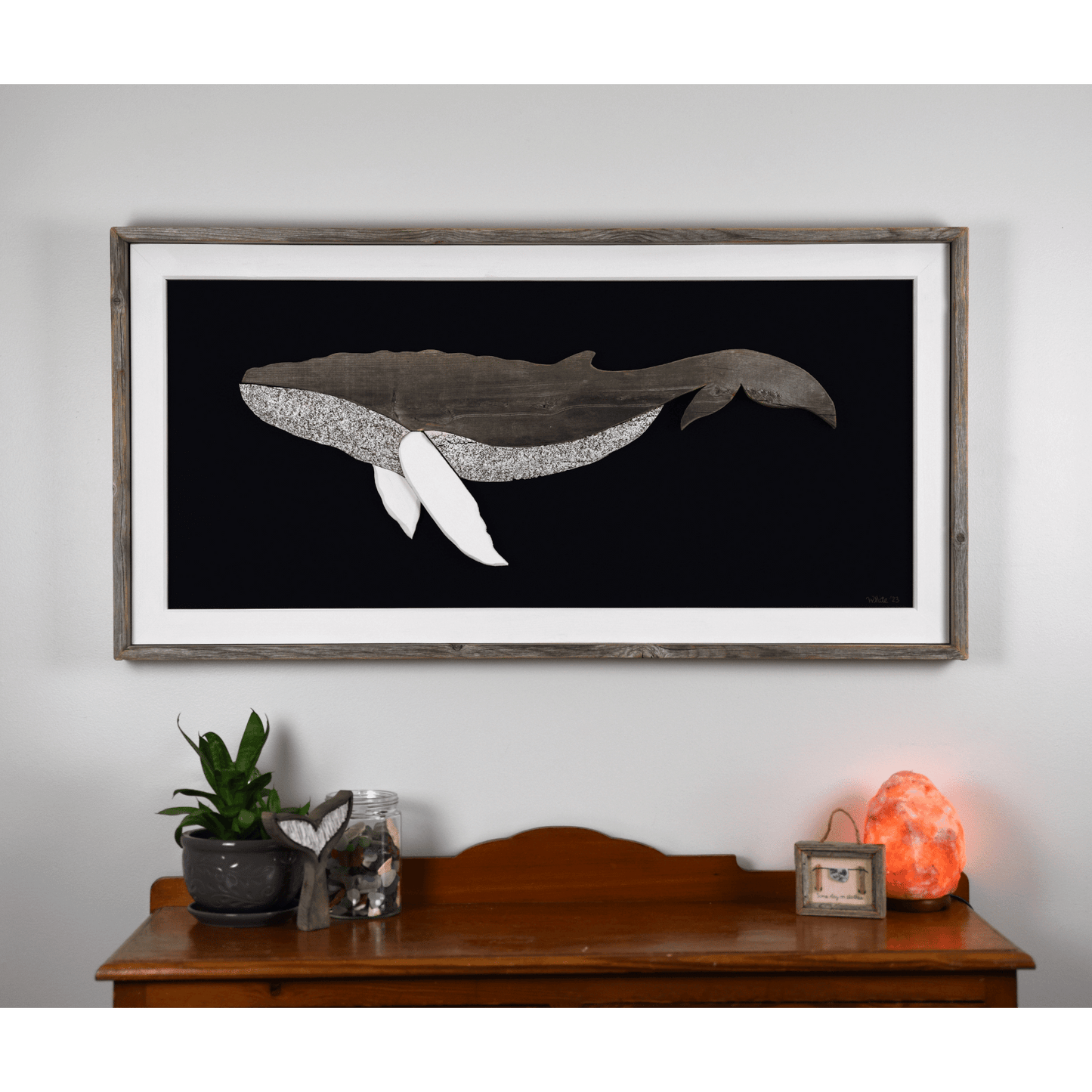 The Grandback features a whale made from reclaimed wood and driftwood with driftwood/reclaimed wood frame, white pine inside trim, and a navy or black canvas backing.