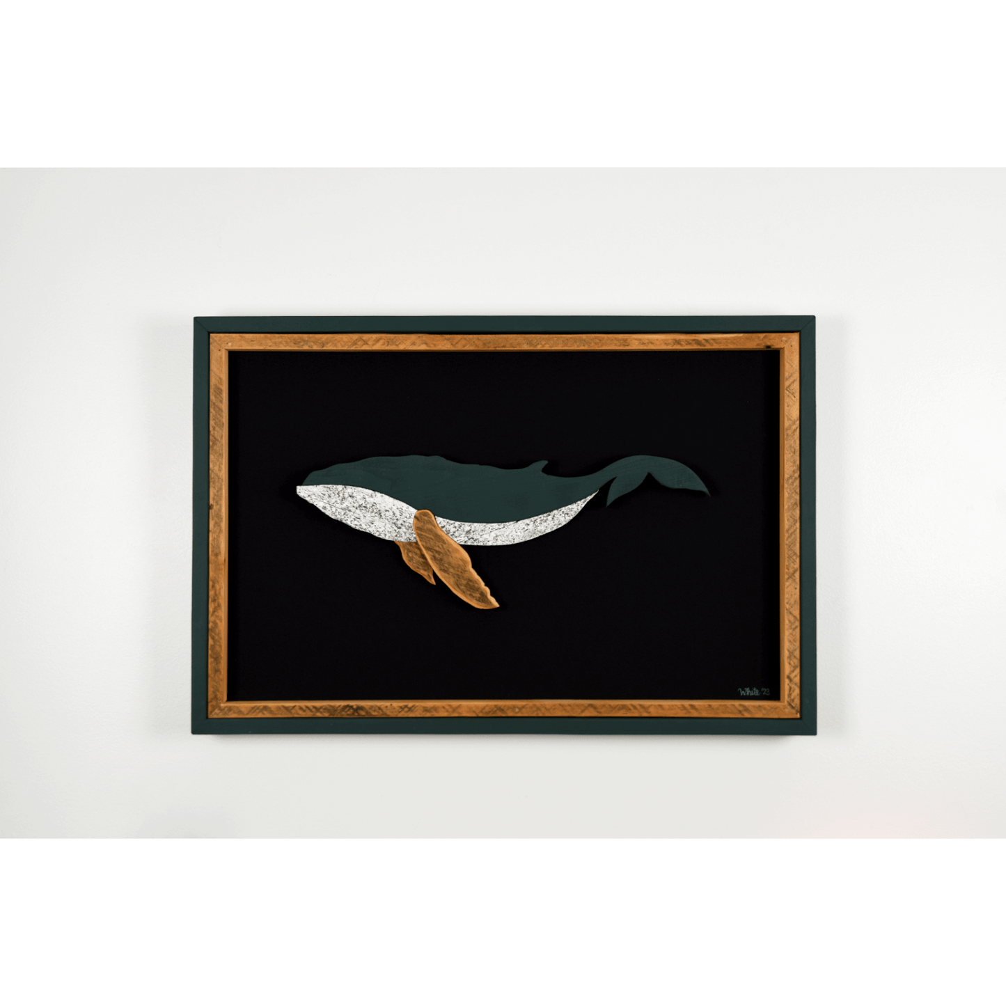 The Humpback showcases a humpback whale made from reclaimed wood and driftwood with green exterior frame, brown tone wood interior trim and fins, and a black canvas.