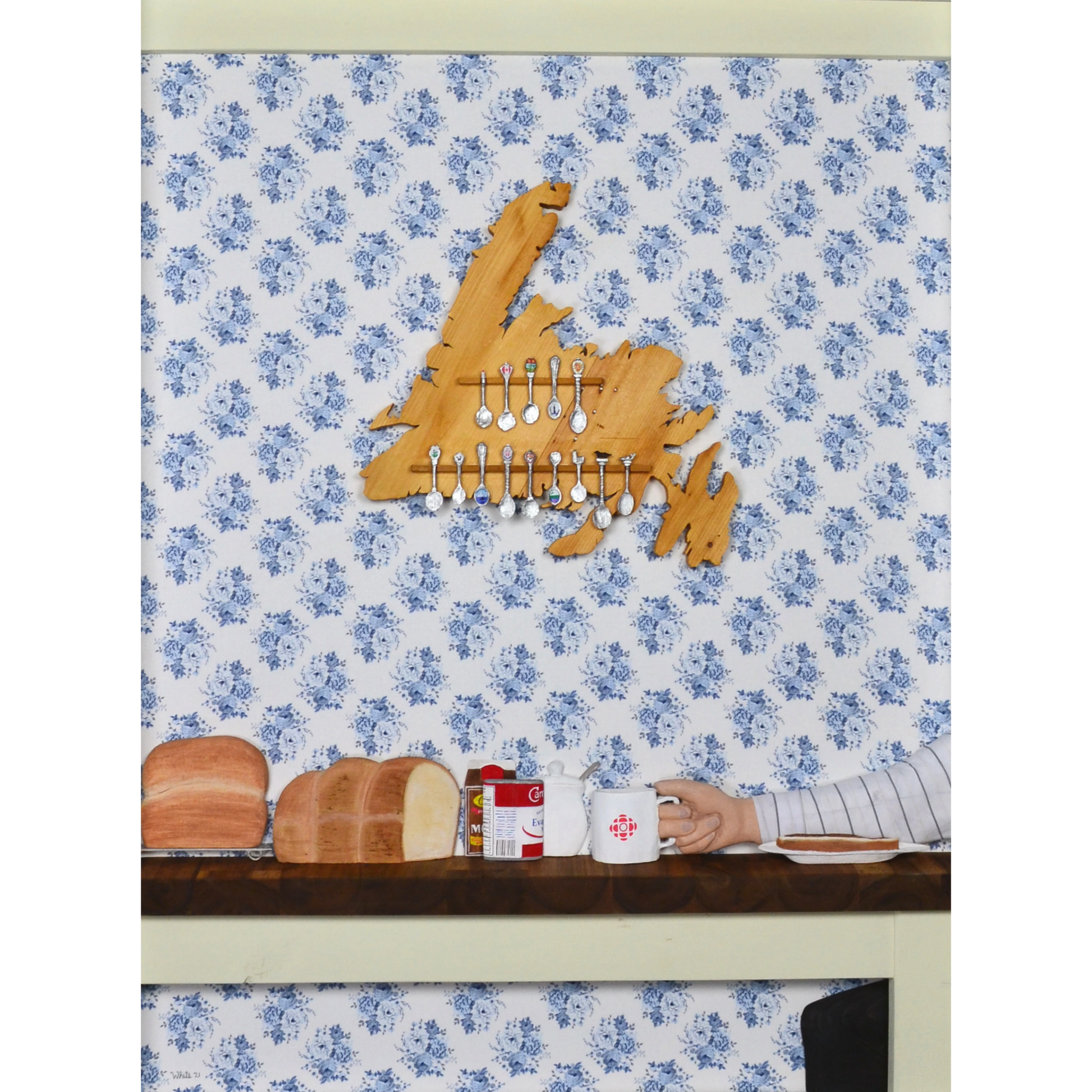 "Stealing the Healtap" print captures the warmth of a cozy family meal at Nan's, with bread, a mug, and a wooden spoon holder shaped like Newfoundland.