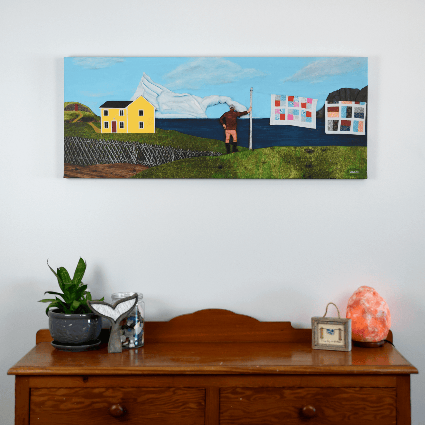 "Living Amongst Giants" canvas captures a classic Twillingate scene with a man watching an iceberg pass the shores of Newfoundland.