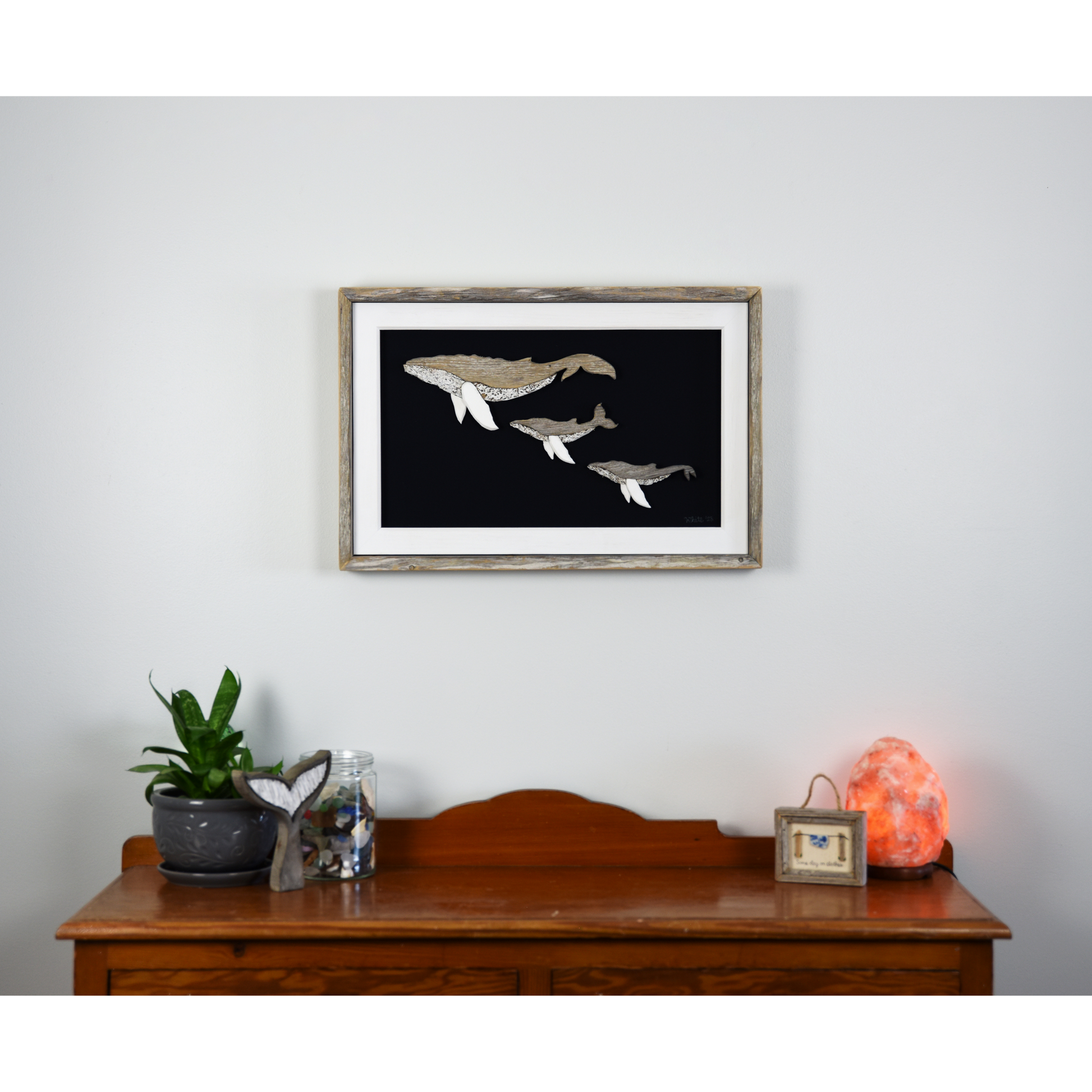 The White's Emporium's driftwood art piece features three humpback whales, a mother and 2 calves, made from reclaimed wood and driftwood sourced in Newfoundland.