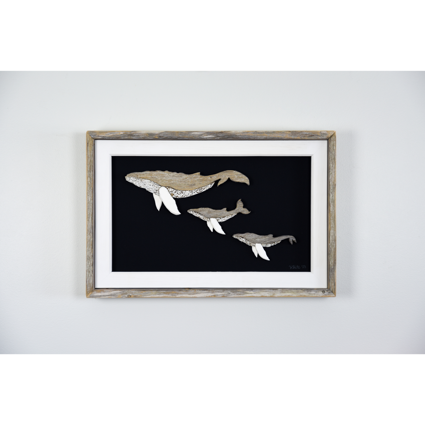The White's Emporium's driftwood art piece features three humpback whales, a mother and 2 calves, made from reclaimed wood and driftwood sourced in Newfoundland.