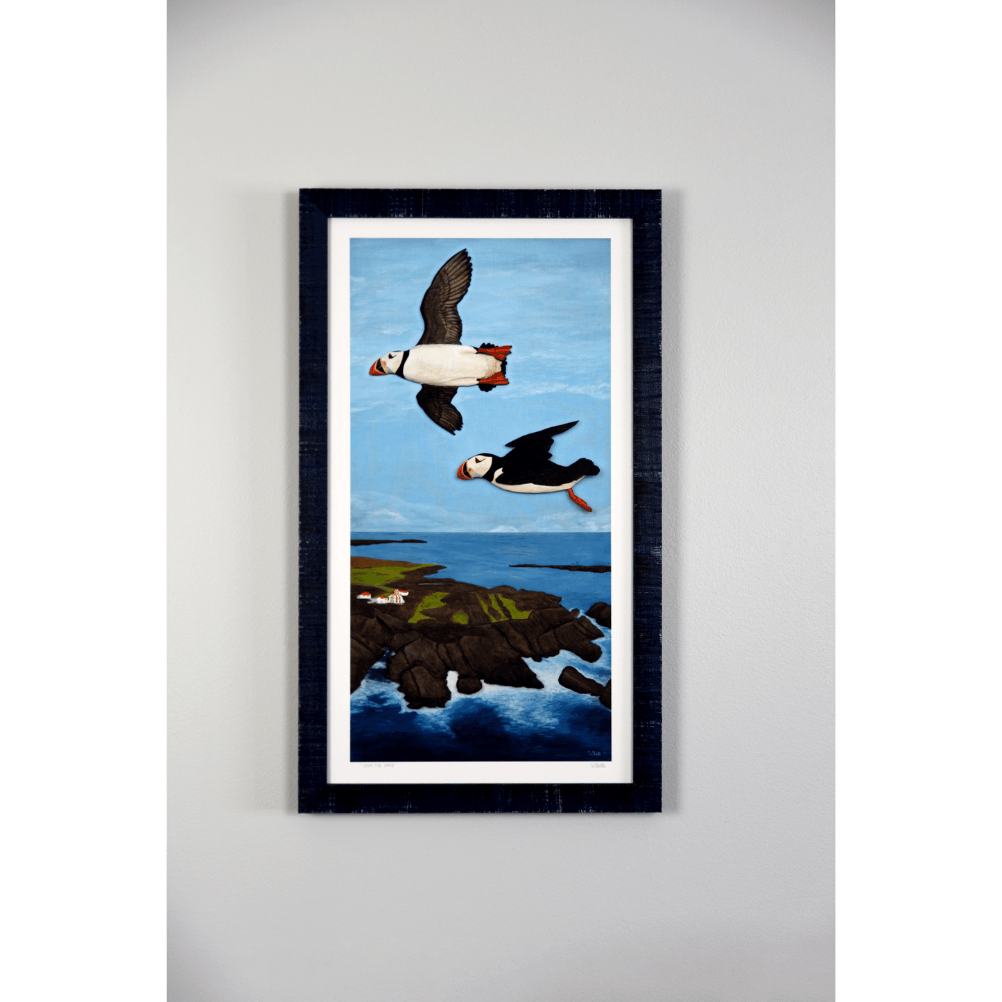 "Over the Cape" reproduction print showcases two puffins flying over the rugged Newfoundland coast.