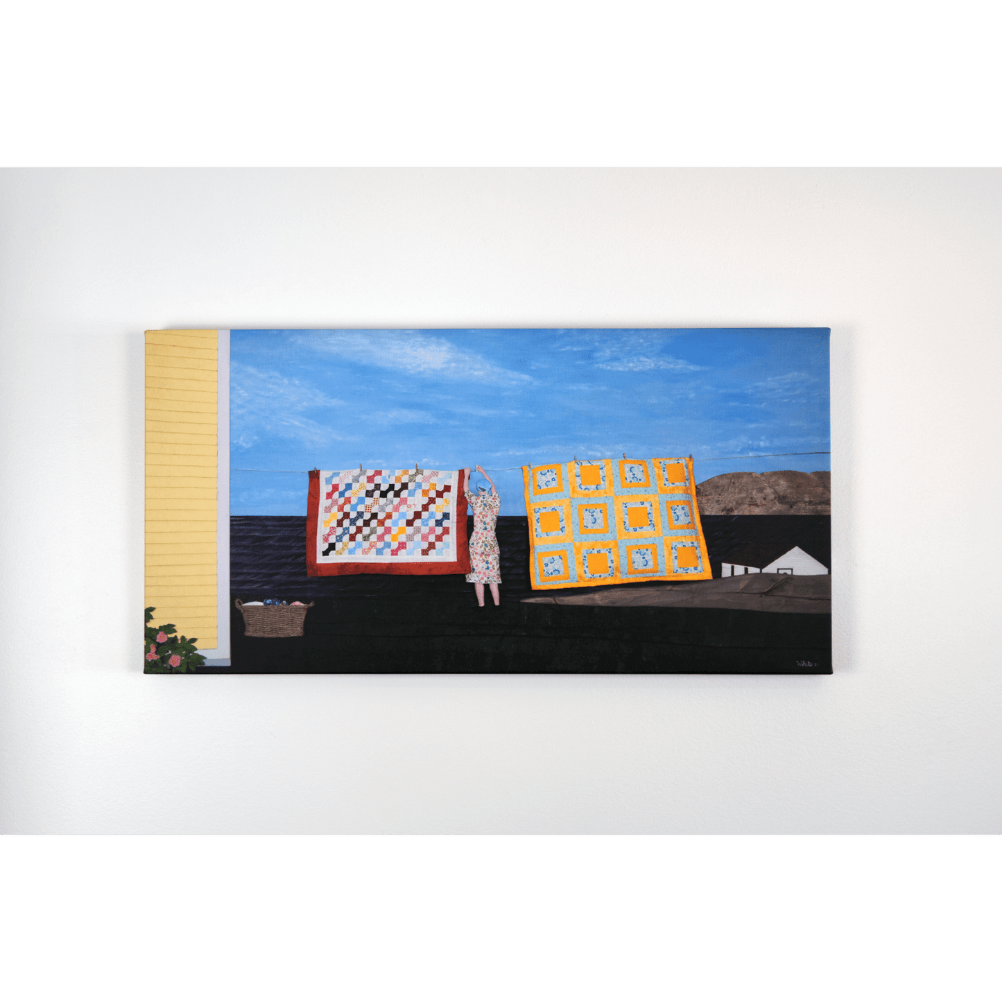 "Quilts" canvas print features a woman in a yellow dress hanging quilts with the ocean and Twillingate coast in the background.