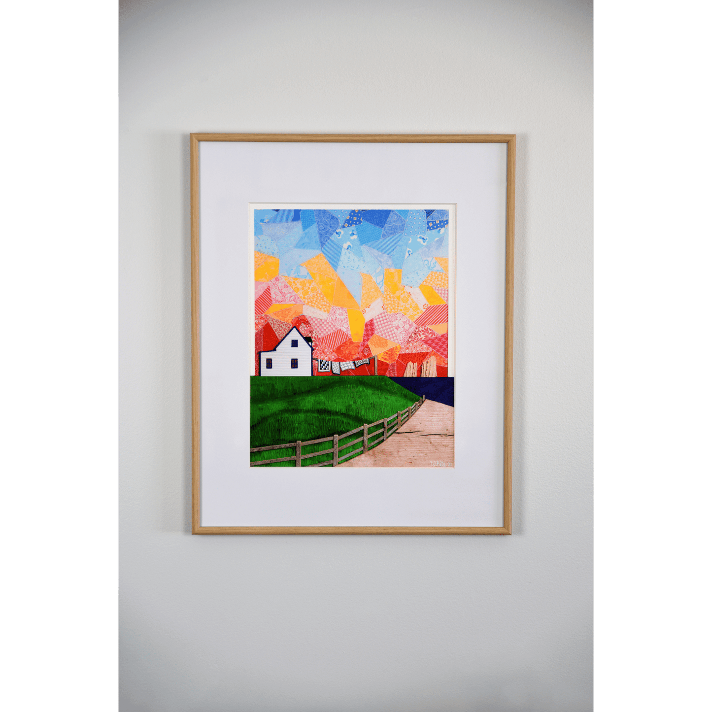 "Twillingate Sunrise" is a serene reproduction print showcasing a house against a patchwork pink and orange sky, with a green lawn and ocean in the foreground.