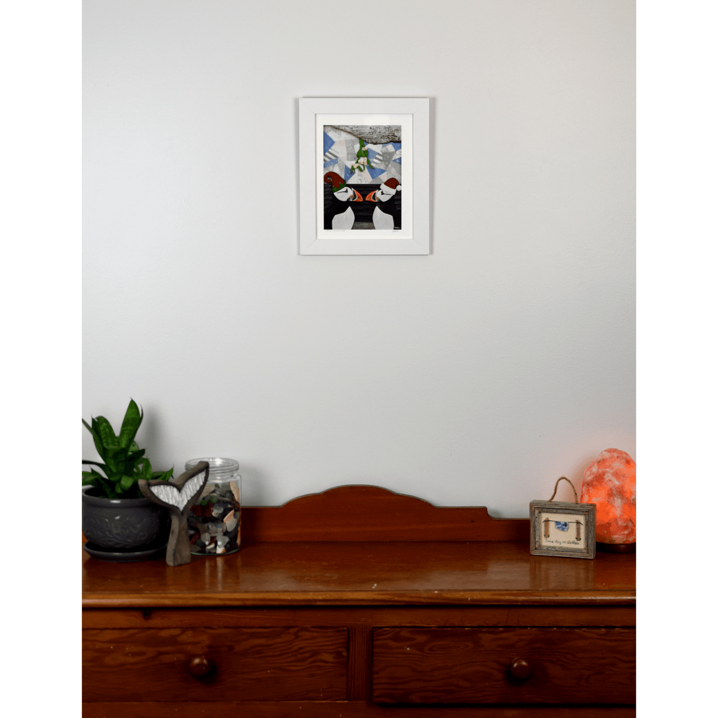 Add a playful touch to your holiday decor with our "Under the Mistletoe" print. It features 2 charming puffins in Santa and Elf hats, kissing under a mistletoe.