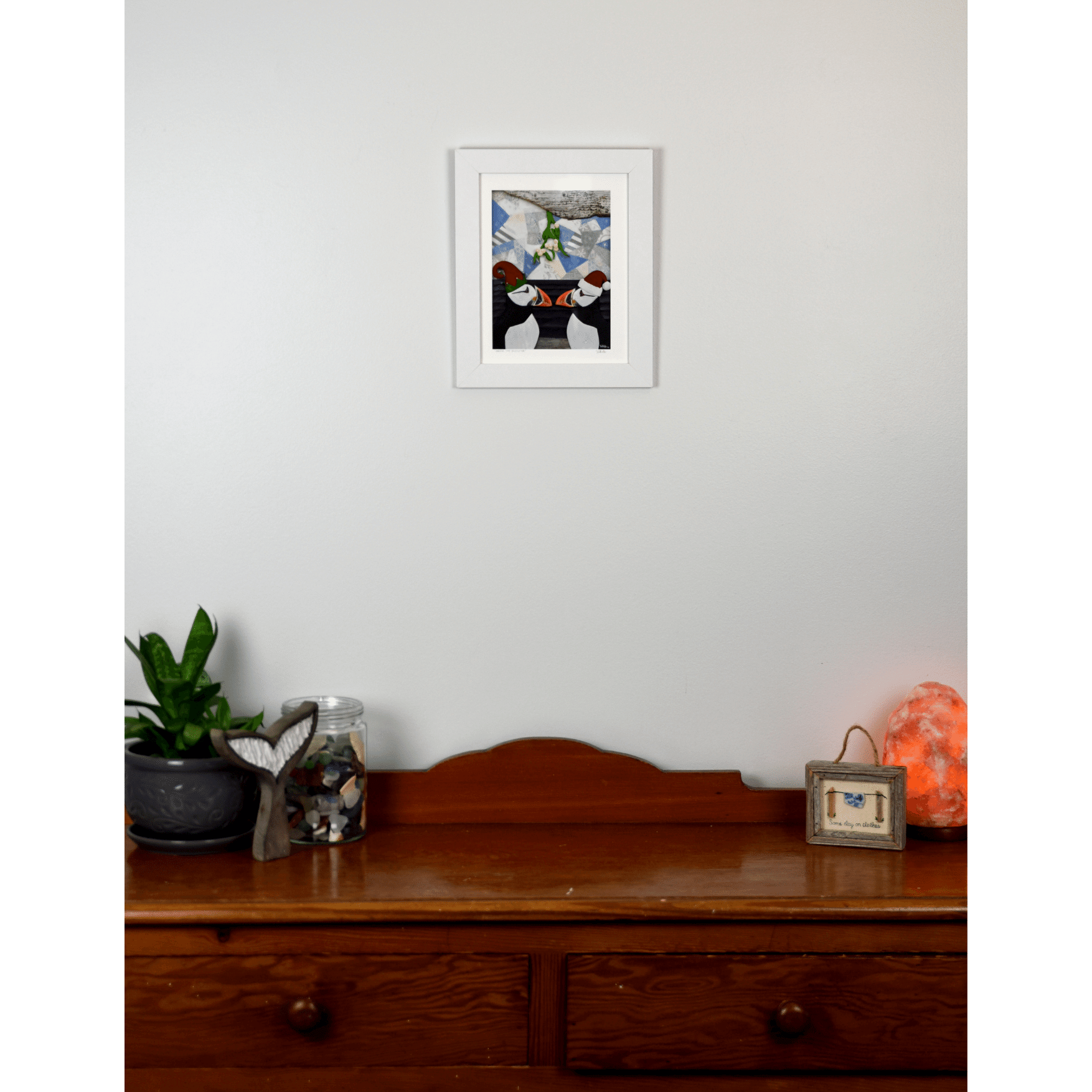 Add a playful touch to your holiday decor with our "Under the Mistletoe" print. It features 2 charming puffins in Santa and Elf hats, kissing under a mistletoe.