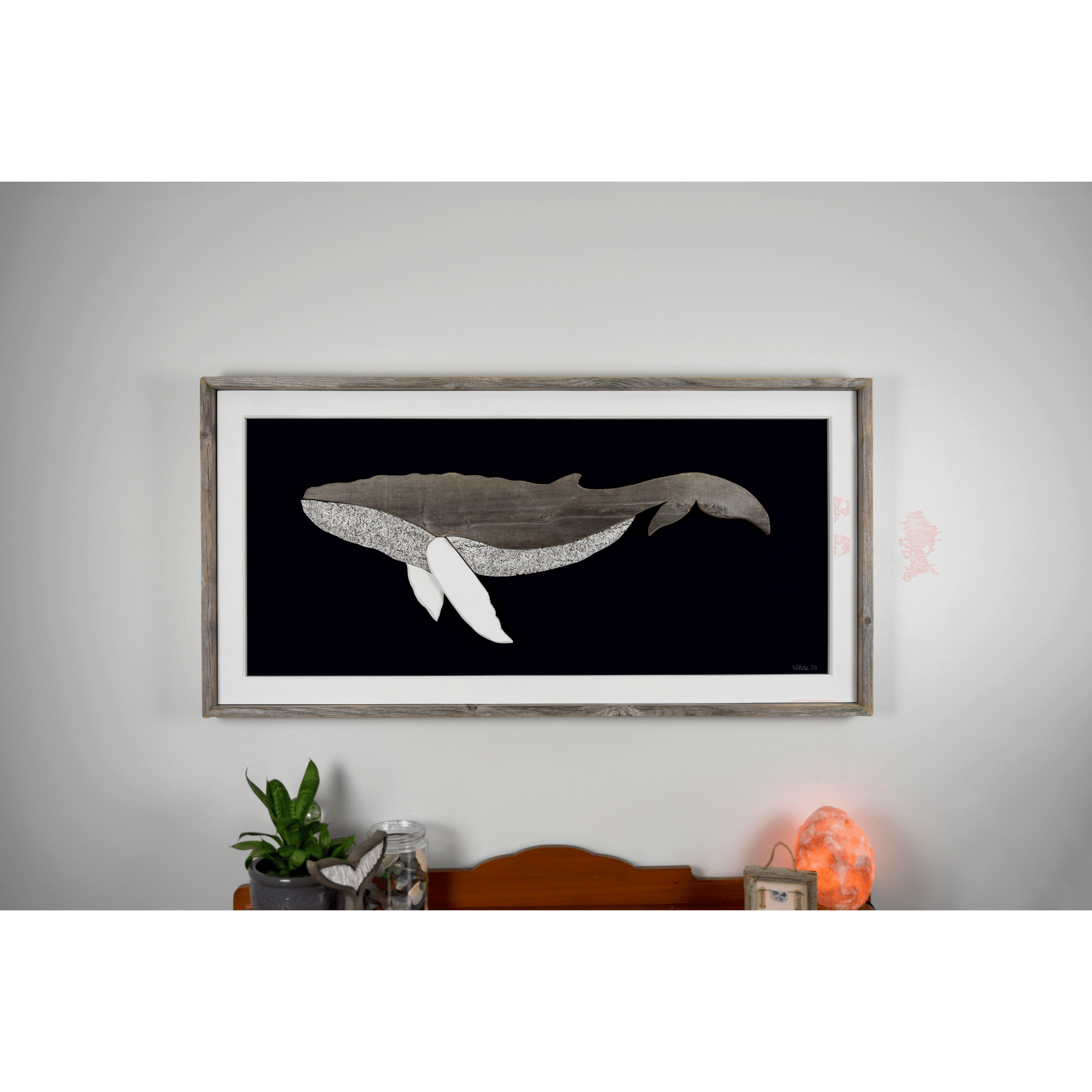 The Grandback features a whale made from reclaimed wood and driftwood with driftwood/reclaimed wood frame, white pine inside trim, and a navy or black canvas backing.