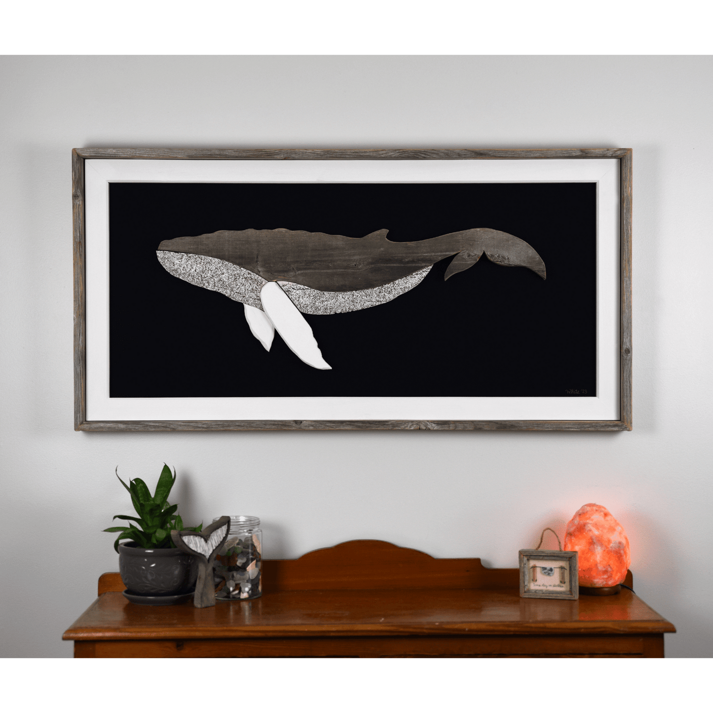 The Grandback features a whale made from reclaimed wood and driftwood with driftwood/reclaimed wood frame, white pine inside trim, and a navy or black canvas backing.