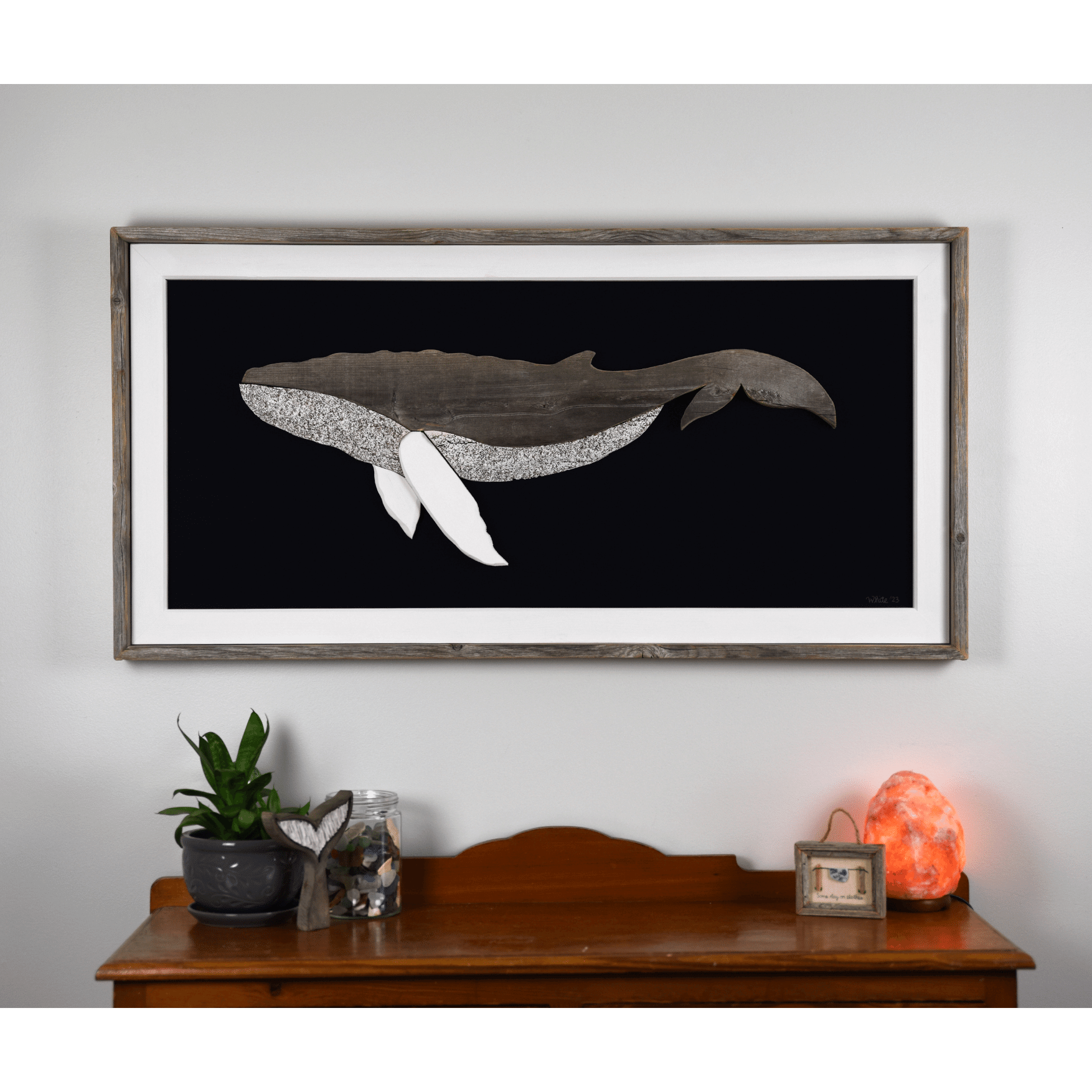 The Grandback features a whale made from reclaimed wood and driftwood with driftwood/reclaimed wood frame, white pine inside trim, and a navy or black canvas backing.
