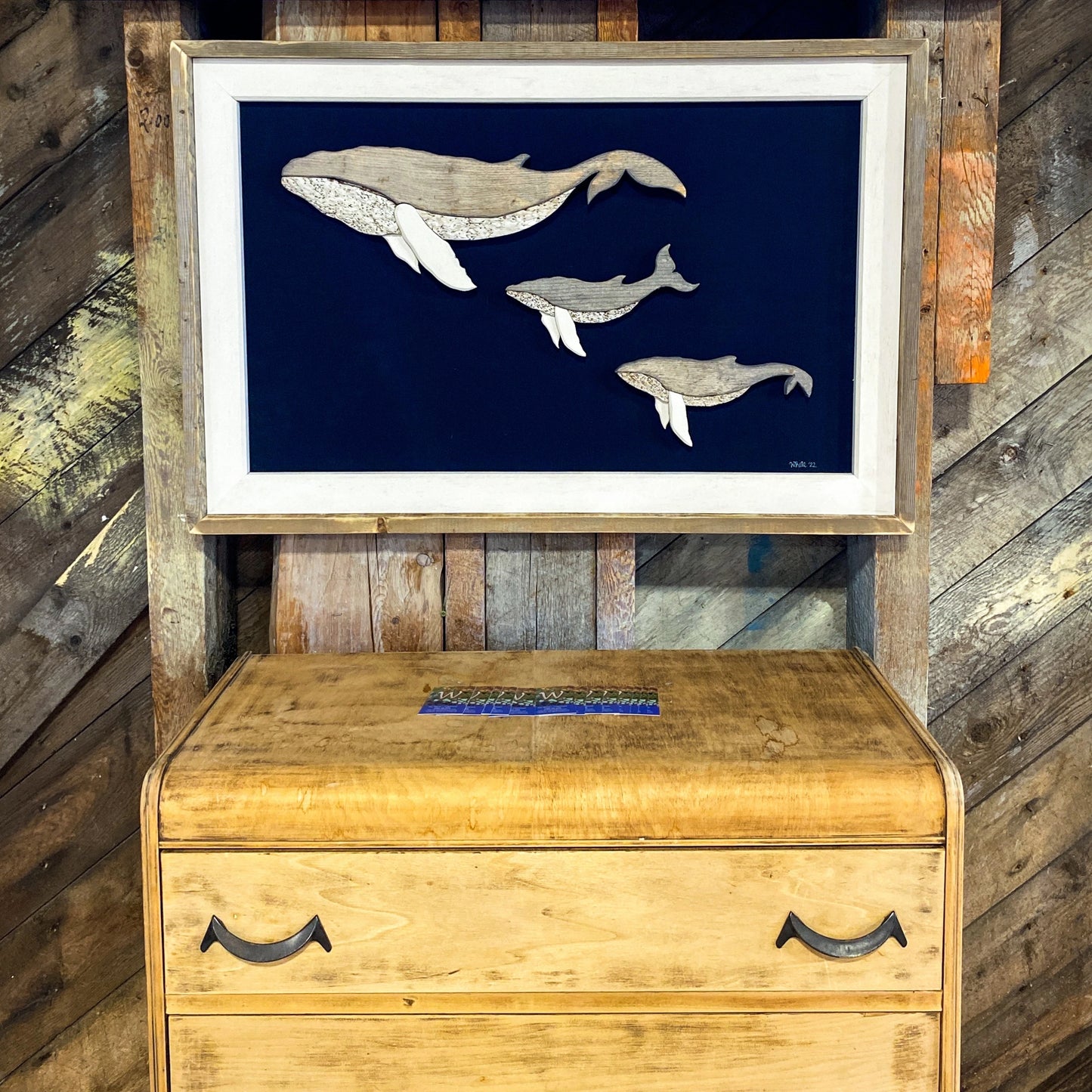 The White's Emporium's driftwood art piece features three humpback whales, a mother and 2 calves, made from reclaimed wood and driftwood sourced in Newfoundland.