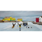Experience the joy of winter in rural Newfoundland with "Still Got It" canvas print. This reproduction features people playing hockey outside. 