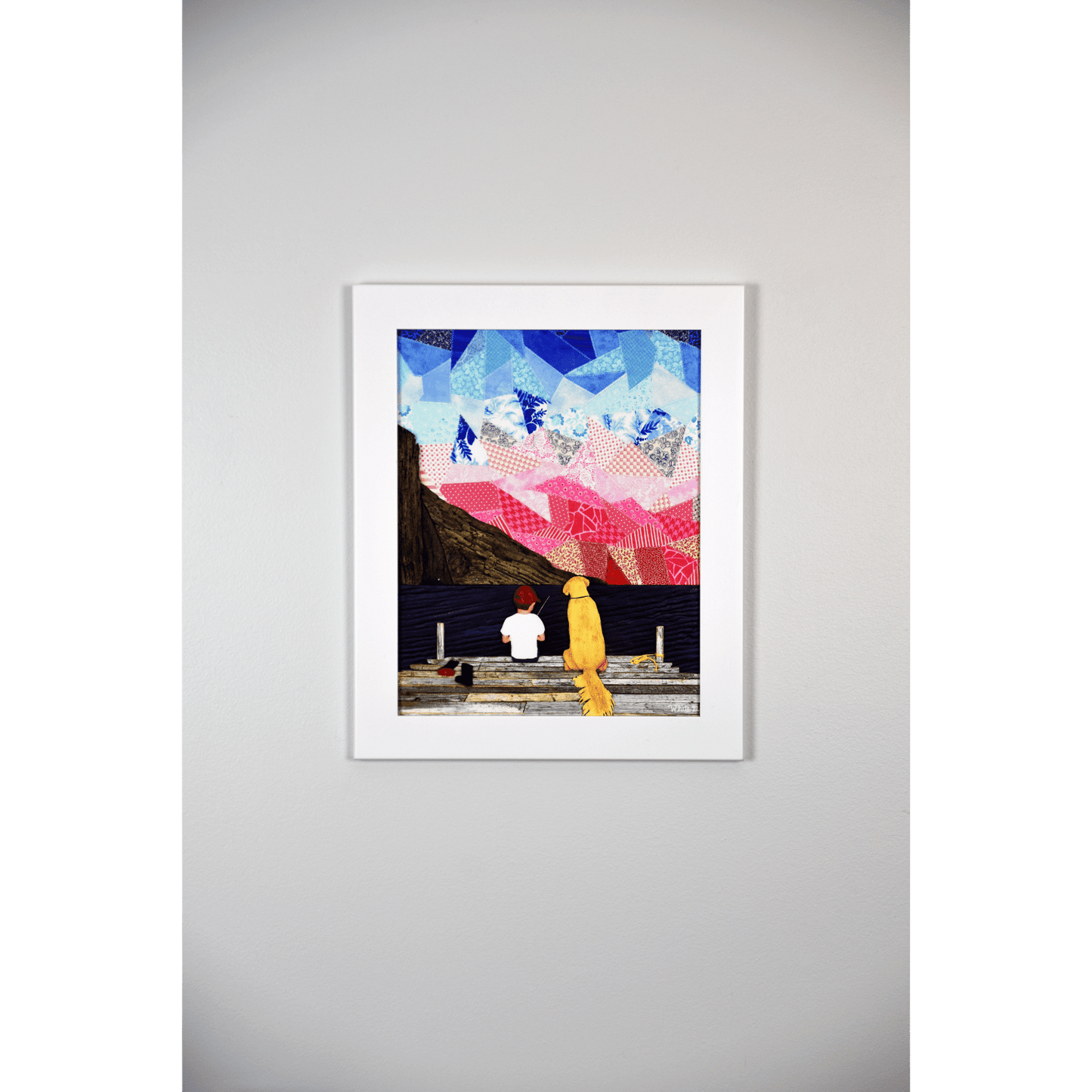 "A Boy and his Dog" print showcases a serene image of a boy sitting on a pier with his loyal yellow Labrador beside him, set against an ocean and sky backdrop.