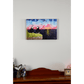 "The Perfect View" reproduction canvas showcases two puffins perched on a coastal rock, gazing lovingly at each other while enjoying a sunset over the ocean.