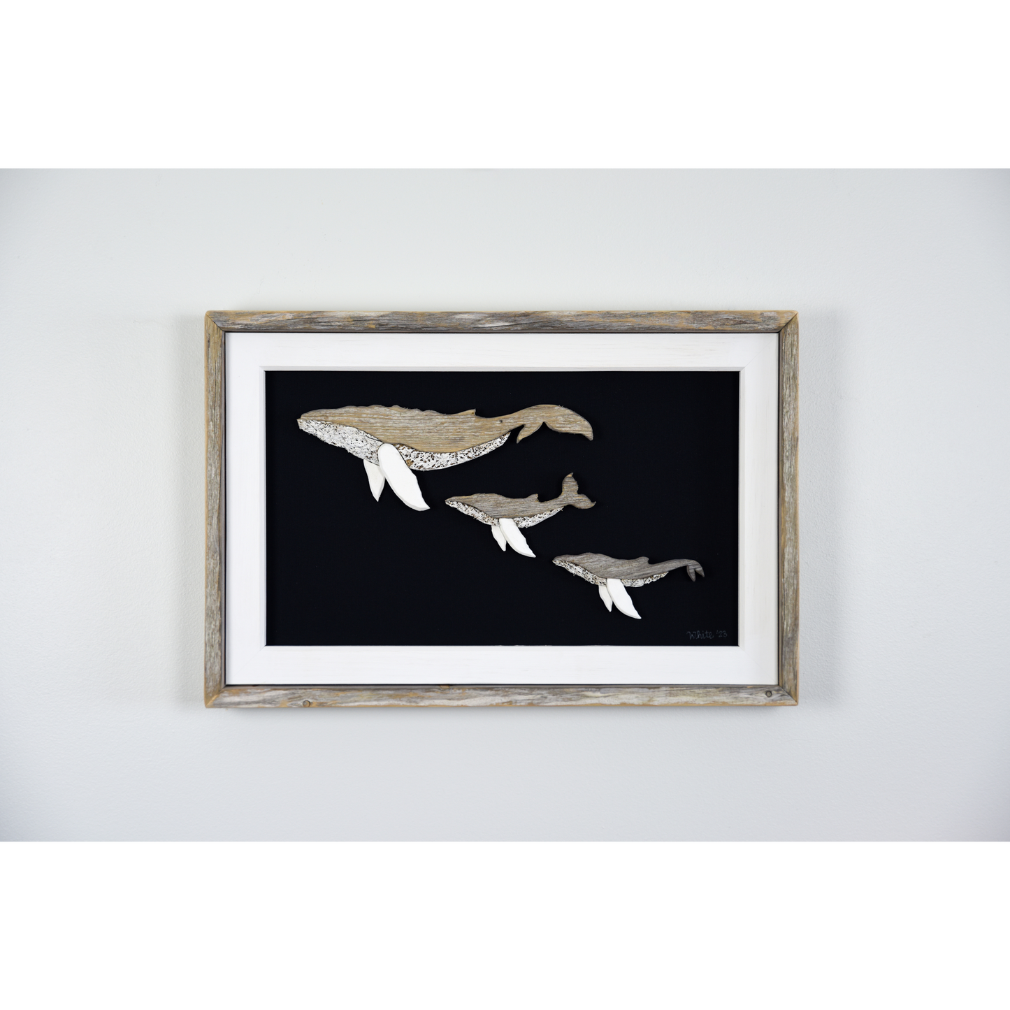  The White's Emporium's driftwood art piece features three humpback whales, a mother and 2 calves, made from reclaimed wood and driftwood sourced in Newfoundland. 