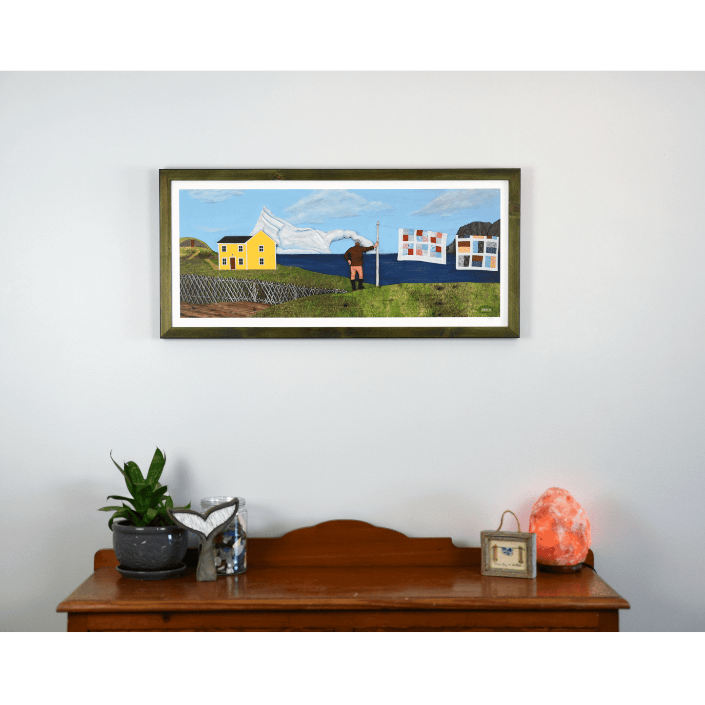"Living Amongst Giants" print captures a classic Twillingate scene with a man watching an iceberg pass the shores of Newfoundland.