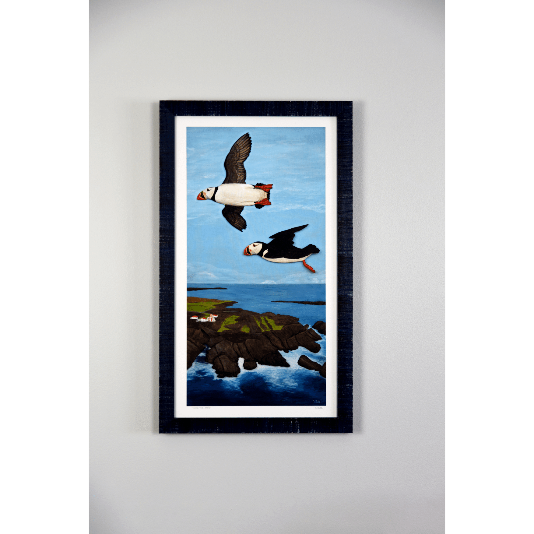  "Over the Cape" reproduction print showcases two puffins flying over the rugged Newfoundland coast.