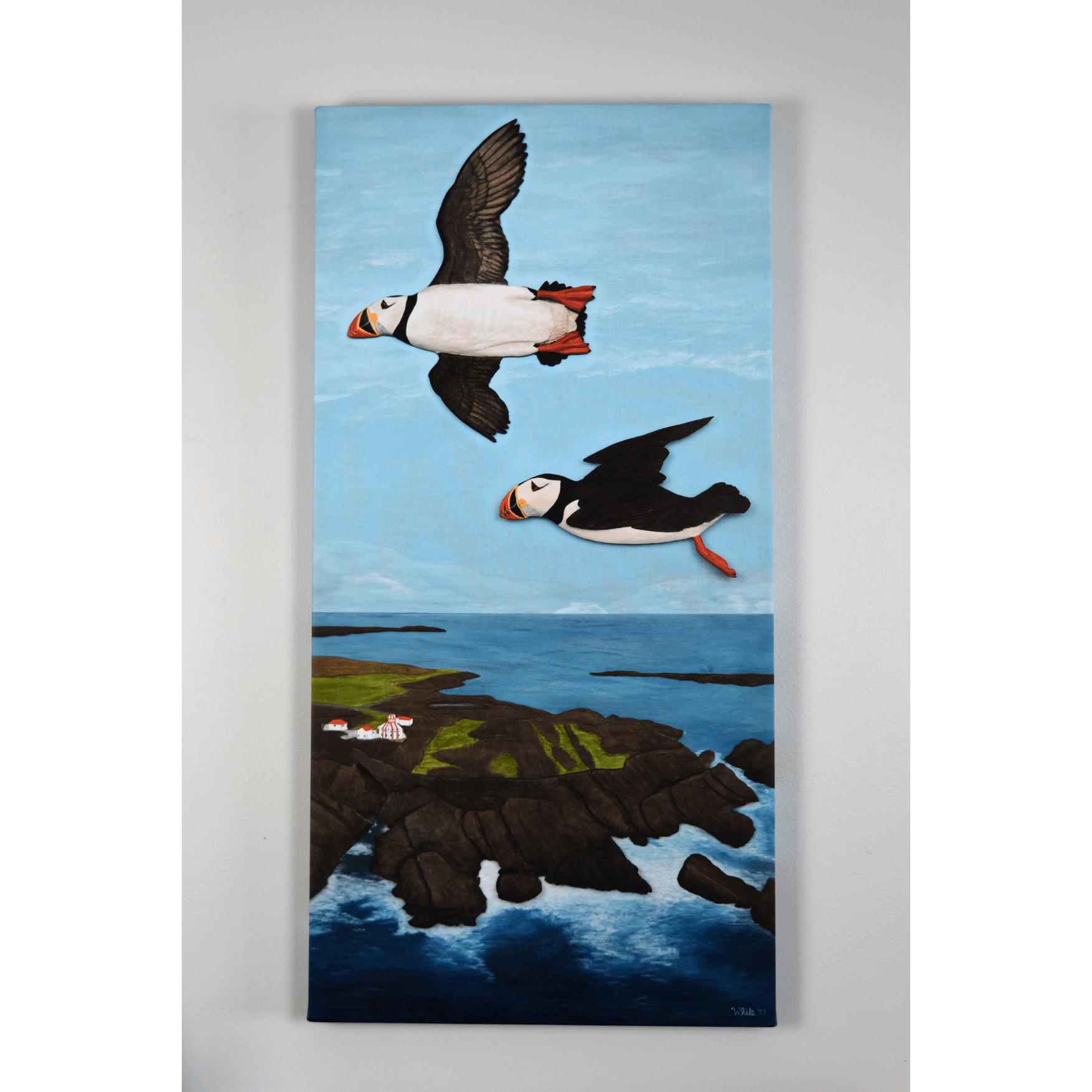 "Over the Cape" reproduction print showcases two puffins flying over the rugged Newfoundland coast.
