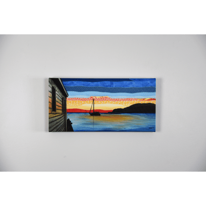 "Silhouettes" is a reproduction canvas that depicts a sailboat at sunset in Back Harbour, Twillingate. The red and orange hues are reflected in the calm ocean.