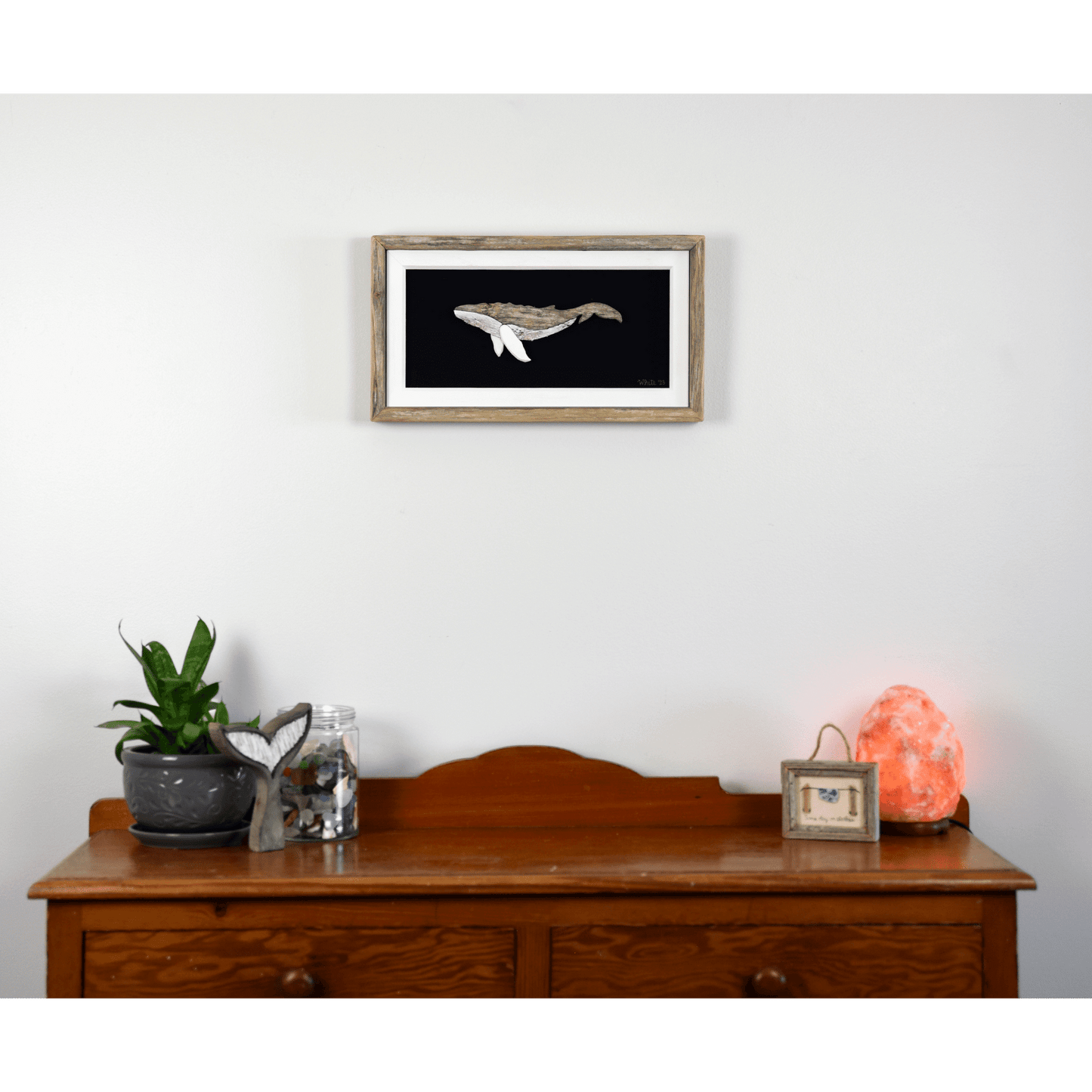   "The Humpback" by The White's Emporium is a mixed media artwork made from various woods and fabric featuring a humpback whale. 