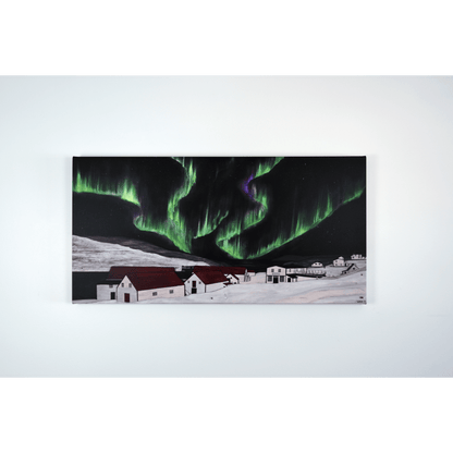 "The Northern Lights of Battle Harbour" canvas showcases the vibrant colours of the aurora borealis over historic Battle Harbour in Newfoundland, Canada.