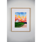  "Twillingate Sunrise" is a serene reproduction print showcasing a house against a patchwork pink and orange sky, with a green lawn and ocean in the foreground.  